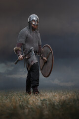 Medieval warrior in full armor with an ax in armor. Historical concept