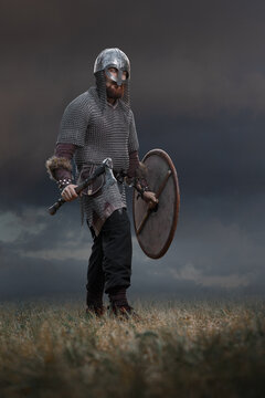 Medieval warrior in full armor with an ax in armor. Historical concept