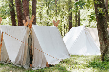 Folk camping lifestyle, reconstruction of life of Middle Ages. Medieval campground in forest,...