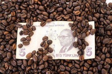 The Turkish lira on roasted coffee beans. The concept of rising food prices, the global food crisis.