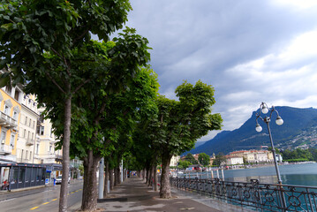Fototapeta premium Scenic view of bay of Lake Lugano, Canton Ticino, on a cloudy summer day. Photo taken July 4th, 2022, Lugano, Switzerland.