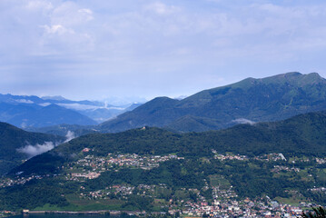 Aerial scenic view over region of Lugano, Canton Ticino, on a cloudy summer day. Photo taken July 4th, 2022, Lugano, Switzerland.