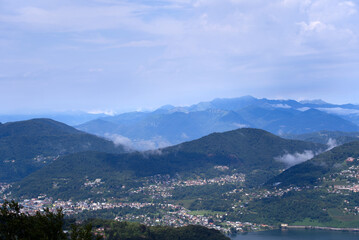 Fototapeta na wymiar Aerial scenic view over region of Lugano, Canton Ticino, on a cloudy summer day. Photo taken July 4th, 2022, Lugano, Switzerland.