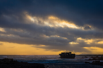 The sun sets beneath a dramatic sky at the wreck of the Meisho Maru No. 38 on the beautiful Cape...