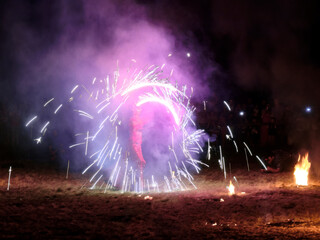 Night show dance with fire surrounded by streaks of sparks and fire