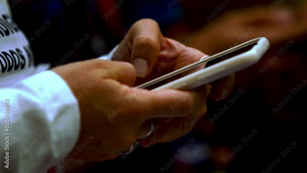 Poster unknown woman using smartphone on a public event for texting