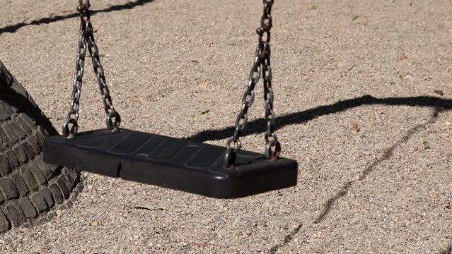 Shadow Of Swinging Swing On Abandoned Playground In Lockdown Without Children In Empty Park Shows Imprisonment On Nostalgic Playful Outdoor Activity Playground Suspended By Government Without Freedom