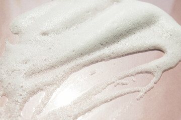 cleanser face foam texture on pink background