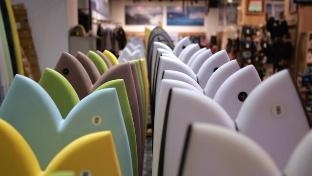 Close-up in slow motion from left to right shows a wide range of sports equipment for surfing for the most demanding taste. In this place you will find everything you need.