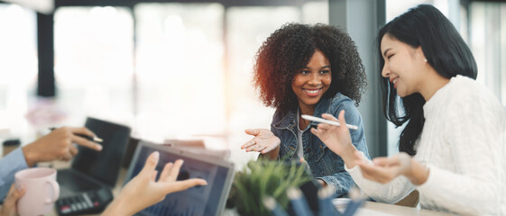 Creative female executives talking and discussing in office.