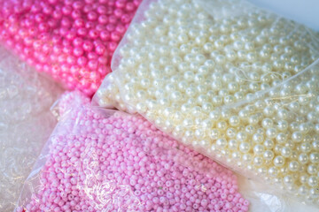 beads and beads in the package. many different pink and white beads. materials for creativity.