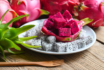 dragon fruit slice on white plate with pitahaya background, fresh white and pink red purple dragon...