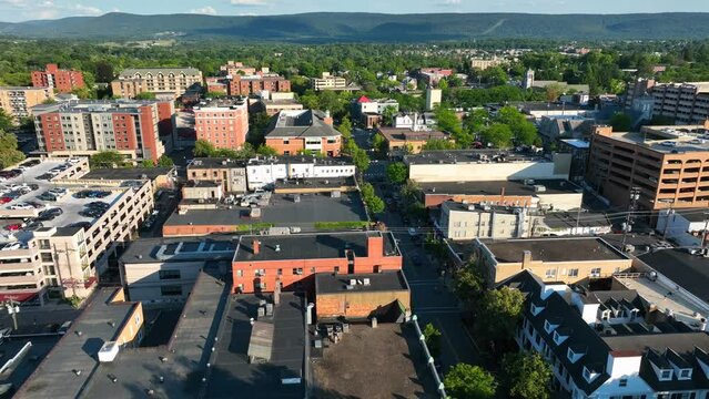Downtown State College PA in warm summer sunset. Aerial of Penn State University city. Truck shot.