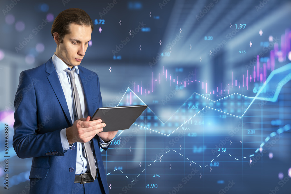 Poster businessman using tablet with abstract glowing candlestick forex chart with index and grid on blurry office interior background. Invest, trade, finance ans stock market concept. Double exposure.