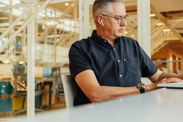 Focused businessman reading notes on desk in office