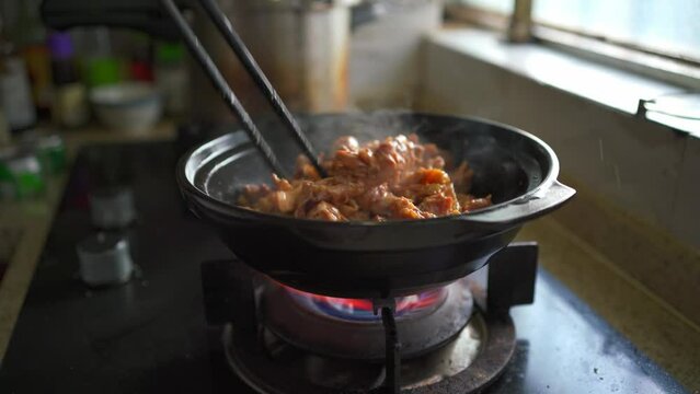 A chef is making a delicious kebab pot, sand ginger chicken