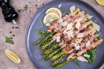 Healthy food - Asparagus wrapped with bacon and spices on a plate