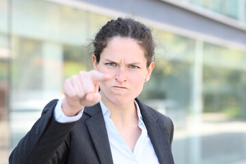 Angry businesswoman accussing pointing you in the street