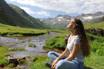 Casual woman resting breathing in a mountain valley