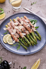 Healthy food - Asparagus wrapped with bacon and spices on a plate