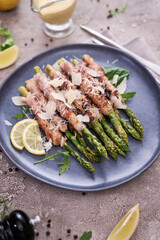 Healthy food - Asparagus wrapped with bacon and spices on a plate