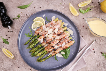 Healthy food - Asparagus wrapped with bacon and spices on a plate