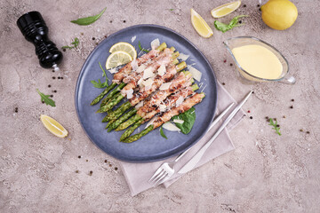 Healthy food - Asparagus wrapped with bacon and spices on a plate