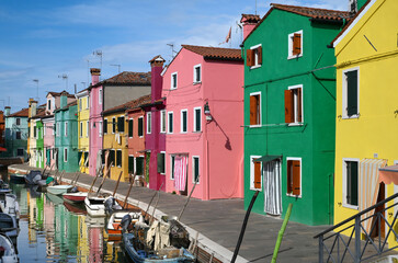 Fototapeta na wymiar Boats in canal near colorful houses in Burano Island