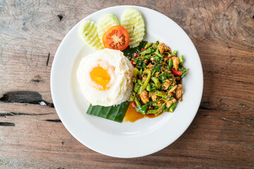 rice and stir fried chicken with basil and fried egg on top