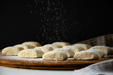 lazy dumplings are sprinkled with flour from the top, blank on a wooden board