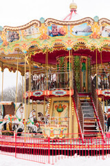 colorful carousel in amusement park in winter