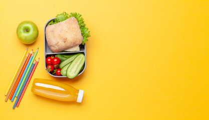 Lunch box with sandwich, vegetables and juice