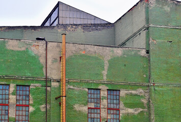 Fragment of the facade of an old industrial building on a summer day
