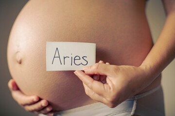 A pregnant mom having a aries baby. Aries sign.