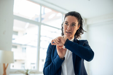 Businesswoman sending voicemail through smart watch