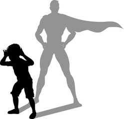 A superhero child or kid boy revealed by his shadow silhouette as a super hero in a cape.