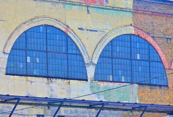 Fragment of the facade of an old industrial building on a summer day