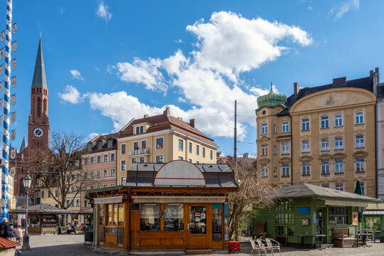 Germany, Bavaria, Munich, Wiener Platz in summer with cafes in foreground and New Saint Johns Church in background