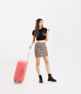 Young asian woman long hair in black crop top t-shirt carrying pink luggage to travelling on white background.