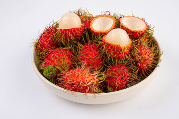 Rambutan fruits in white plate on white background, top view.,Close-up