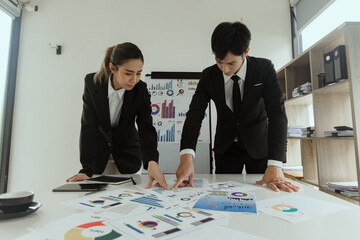 Technology and financial advisory services concert. Business teamwork and working on digital laptop computer with advisor showing plan of investment to clients at table office. Digital marketing.