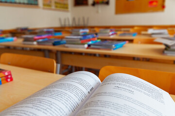 Notebooks on the desks in a school classroom ready for the beginning of the new school year