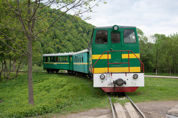 Old narrow-gauge tourist train in Ukrainian Carpathian mountains