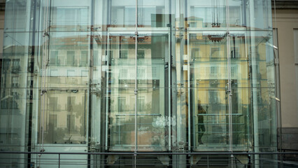 Glass facade with the elevator and reflection, Madrid

