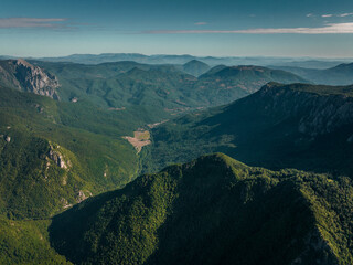 Maglic Mountain on the border of Bosnia and Herzegovina and Montenegro with canyon, Aerial Shot with golden sunlight valley (wide) - Sutjeska	 - obrazy, fototapety, plakaty