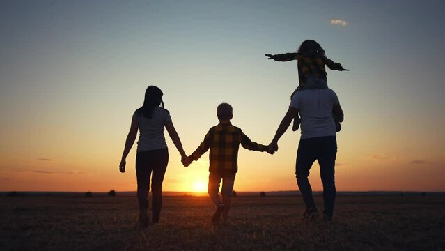 people in the park. friendly family a walking holding hands. happy family kid dream concept. big family walk on vacation running together in nature in the park lifestyle. happy silhouette family