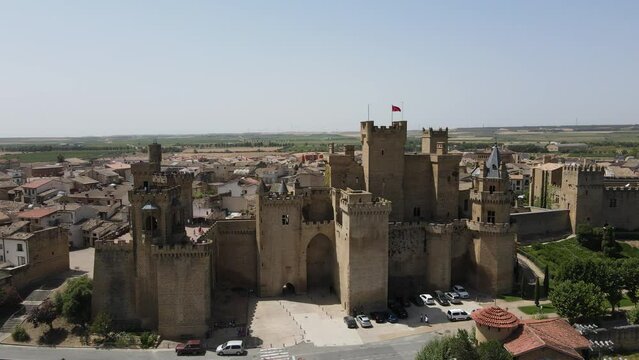 Stunning Olite Castle with flag flying on a warm sunny day, dolly right.