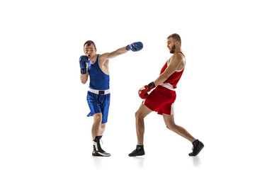 Fototapeta na wymiar Dynamic portrait of two professional boxer in sports uniform boxing isolated on white background. Concept of sport, competition, training, energy