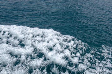 white foamy waves on the sea. behind the ferry boat.