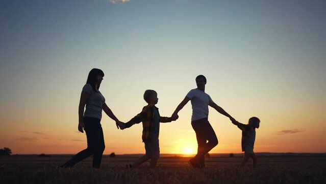 people in the park. friendly family a walking holding hands. happy family kid dream concept. big family walk on vacation running together in nature in the park silhouette lifestyle. happy family